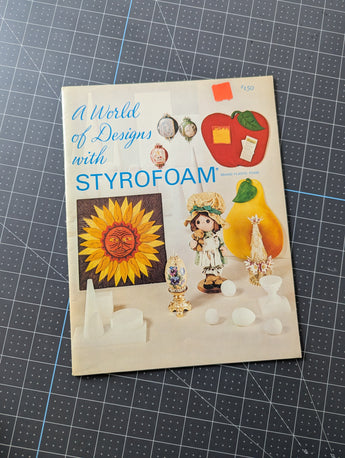 Styrofoam packaging with colorful graphics on a grid background