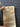 Brown paper bag with text and diagrams held by a hand on a grid background
