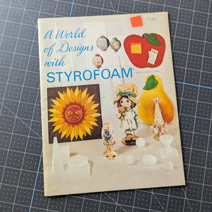 Styrofoam packaging with colorful graphics on a grid background